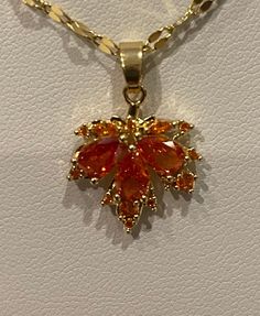 Red maple leaf pendant, necklace,  inlaid zircon, gold plated Comes complete with a SS goldenchain and a velvet gift bag beautiful gift for any occasion Pendant height and width: 1.5 cm stainless steel Chain length 40-45 cm/15.75-17.75 inches Please have a look at the other items in my store. I ship all multi-item purchases in the same package. You will only be charged for the actual shipping cost if applicable. I will issue a credit to your payment method for any overcharge in shipping.  If you Leaf-shaped Yellow Gold Necklace, Leaf-shaped Yellow Gold Necklace For Gift, Leaf-shaped Yellow Gold Plated Jewelry, Yellow Gold Plated Leaf-shaped Jewelry, Yellow Gold Leaf-shaped Jewelry Gift, Gold Leaf-shaped Jewelry Gift, Gold Plated Leaf-shaped Jewelry, Gold Plated Leaf-shaped Jewelry For Gifts, Orange Jewelry With 17 Jewels As A Gift