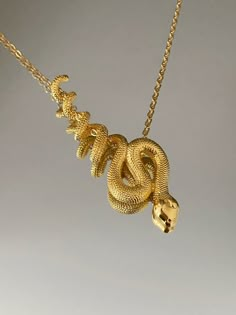 SNAKE NECKLACE This product is brass and gold plated. ♡ The most unique jewelry you can find, perfect gift for you and your loved one. ♡ All of our jewelry is handcrafted with enthusiasm and great care in our workshop. ► HOW TO CARE FOR YOUR JEWELRY * Maintain your jewelry's high shine by avoiding contact with any chemicals such as soap, perfume, lotion, makeup, hair & cleaning products. * Keeping your jewelry in a pouch or a box after using it will prolong the life of your jewelry. * Not recomm Symbolic Snake-shaped Brass Jewelry, Snake-shaped Metal Necklace For Gift, Metal Snake Shape Necklace As Gift, Metal Snake-shaped Necklace For Gift, Gold Snake-shaped 14k Gold Necklace, Gold Snake Shape 14k Gold Necklace, Unique Gold Snake Chain Jewelry, Unique Gold Jewelry For Anniversary, Yellow Gold Snake Chain Brass Jewelry