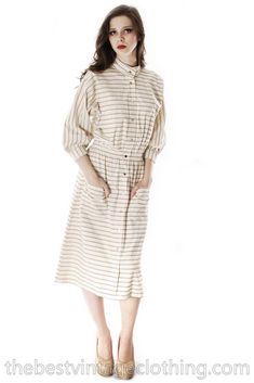 "Cool 1970s Vuokko Mod vintage 100% cotton shirt dress or coat dress in a natural color background with black and taupes stripe pattern. The shape very straight, with shirred elasticised waist and large front patch pockets. Unlined. 3/4 one piece sleeves, cuffed. Incredibly versatile! Can be worn as a light coat. Vuokko Nurmesniemi was a principal designer for Marimekko, and known for bold color and shape combinations, whimsical looks.  Part of a collection that is being sent to me from Finland. Though marked small it may fit a little larger size as the measurements show. Marked Size: S Bust: 50\" Waist: 29\" stretch Hips: Free/40\" Shoulders: Sleeve Length (from underarm): 14\" Sleeve Length (from shoulder): Total Length: 47.5\" Length (shoulder to waist): 20\" Length (waist to hem): 27.5 Beige Cotton Shirt Dress For Daywear, Collared Beige Cotton Shirt Dress, Collared Beige Shirt Dress For Daywear, Classic Beige Shirt Dress With Button Closure, Beige Shirt Dress With Button Closure For Daywear, Fall Striped Collared Shirt Dress, Beige Relaxed Fit Shirt Dress For Fall, Striped Shirt Dress For Workwear In Fall, Striped Shirt Dress For Fall Workwear