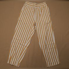 Yellow And White Striped Elastic Waist Cropped Linen Pants With Front Pockets. Never Worn. Length From Front Waist To Ankle: 34 Inches Inseam: 24 Inches 55% Linen, 45% Cotton Yellow Ankle-length Pants With Elastic Waistband, Casual Yellow Ankle-length Bottoms, Casual Yellow Ankle-length Pants, Yellow Loungewear Bottoms With Pockets, Yellow Bottoms With Pockets For Loungewear, Yellow Pants With Elastic Waistband For Loungewear, Yellow Elastic Waistband Pants For Loungewear, Casual Yellow Pants, Yellow Relaxed Fit Ankle-length Pants