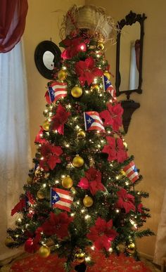 a christmas tree decorated with poinsettias and flags