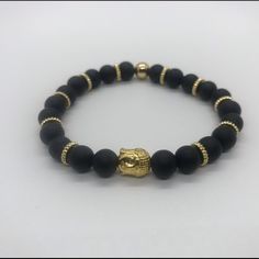 Gold Buddha And Black Beads Combination Creating A Great Piece Of Jewelry For Any Occasion Adjustable Black Beaded Bracelets With Polished Beads, Black Bracelets With Faceted Round Beads, Adjustable Black Crystal Bracelet With Black Beads, Black Beaded Wristband As Gift, Casual Gold Jewelry With Faceted Beads, Black Round Beads Bracelet For Meditation, Adjustable Black Spiritual Beaded Bracelets, Black Beaded Stretch Bracelet For Meditation, Spiritual Black Polished Beaded Bracelets