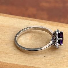 14KT white gold round, faceted amethyst and baguette and round diamond ballerina design ring. Size 6.5 (1) Genuine Round Faceted Amethyst Measures approx. 6.5mm Faceted Round and Tapered Baguette Ring Weighs 2.90 Grams 1/6 carat total weight SI2/3 clarity GHI color Prongs-set; One on each side Timeless Round Purple Jewelry, Classic Amethyst Diamond Ring With Brilliant Cut, Timeless Purple Round Jewelry, Elegant 14k White Gold Amethyst Ring With Center Stone, Elegant White Gold Amethyst Ring With Round Cut, Round White Gold Amethyst Ring, Classic Silver Amethyst Diamond Ring, Purple Diamond Ring With Accents, 14k White Gold Amethyst Ring With Center Stone