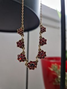 This beautiful antique garnet necklace. Likely made in the middle 20th century. The front piece of the necklace consists of 7 links ang together they hold over 50 prong set bohemian garnets. Necklace length 45cm From the first link to the last 1.4mmx1.7mm 3mmX3.8mm Middle link (approx) 5mmx5.5mm Hardness: 6.5-7.5 Density: 3.51-4.25 Natural Gemstone All garnets are intact and there are no missing stones. Very good condition. Your jewelry will be sent in personalized packaging. Shipments are monitored by LA Poste. You can track the shipment -By registered letter -Colissimo If you have any further questions regarding the items. Please do not hesitate to contact me. I am happy to answer your questions as quickly as possible. Victorian Ruby Necklace For Formal Occasions, Vintage Ruby Necklace For Formal Occasions, Antique Ruby Necklace For Formal Occasions, Vintage Red Gemstone Necklace, Vintage Ruby Gemstone Necklaces, Victorian Garnet Necklace Gift, Victorian Garnet Necklace For Gift, Victorian Garnet Necklace, Vintage Garnet Gemstone Necklace