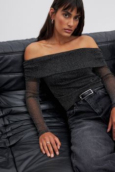 This long sleeve top features a form fit and an off shoulder design. It has a glittery stretchy material and a gathered side seam at the shoulders. Glitter Mesh Top, Off Shoulder Design, Mesh Tops, Black Mesh Top, Low Waist Jeans, New Years Outfit, Sleepwear Sets, Business Outfit, New Version