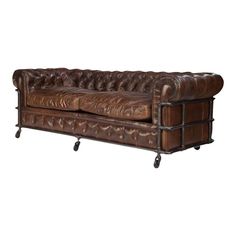 a brown leather couch sitting on top of a wooden table