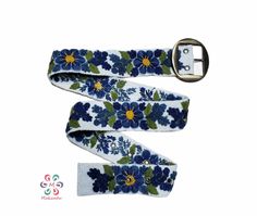 Belts are inspired by the flowers of the Peruvian Andes. Handmade embroidered by women from Ayacucho - Peru The strap is handwoven in wood looms and carefully hand-embroidered with colors that try to replicate the beauty of real flowers we see around us. We decided to be eco-friendly, so we use 100% sheep wool. Material: 100% sheep wool. Design: artistic floral. Width: 5 cm / 2''. It has 7 holes separated by 1'' / 2.5 cm from each other. The first hole is at 2'' / 5 cm from the end It will fit p Handmade Belt, Wool Design, Embroidered Belt, Handmade Belts, Clothing Fabric, White Belt, Handmade Embroidery, Sheep Wool, Blue Flower