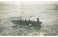 an old black and white photo of people in a boat