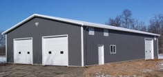 two garages are shown in the middle of a snow covered field, with one door open