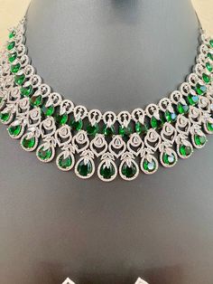 Green Emerald Kundan Necklace With Gemstones, Green Round Kundan Necklace With Gemstone, Green Round Gemstone Kundan Necklace, Green Gemstone Kundan Necklace, Dazzling Green Diamond Necklaces, Green Gemstone Jewelry Sets For Celebration, Green Emerald Jewelry Sets For Celebrations, Dazzling Green Diamond Necklace, Green Cubic Zirconia Jewelry With Stone Work