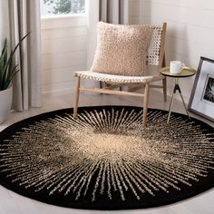 a living room area with a chair and rug on the floor in front of a window