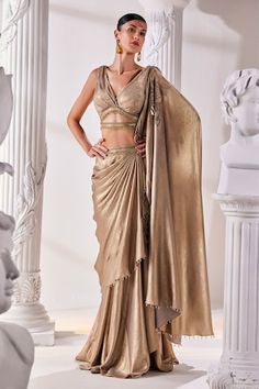 Metallic antique gold pre-draped saree. Paired with a luxurious metallic embroidered blouse with a cutout and tassel details and an embroidered tasseled belt. - Aza Fashions Gold Floor-length Pre-draped Saree With Cutdana, Gold Pre-draped Saree For Diwali Reception, Elegant Draped Sharara With Cutdana, Elegant Draped Cutdana Sharara, Gold Pre-draped Saree For Party, Festive Draped Sharara For Evening, Fitted Gold Pre-draped Saree For Festive Occasions, Festive Wedding Pre-draped Saree, Draped Sharara With Dupatta For Reception