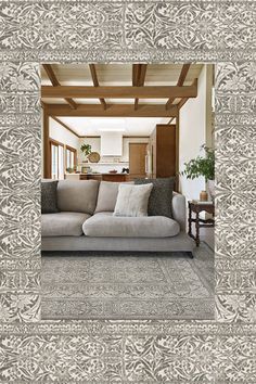 a living room filled with furniture and a wooden ceiling