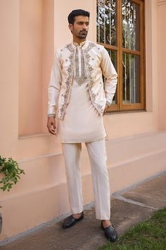 Beige bundi with marodi, dori and zardosi embroidery. Paired with a kurta and pant. - Aza Fashions Navratri Long Sleeve Sherwani With Gota Work, Navratri Sherwani With Gota Work And Long Sleeves, Festive Bandhgala With Gota Work In Straight Kurta Style, Transitional Bandhgala With Gota Work And Long Sleeves, Festive Bandhgala With Gota Work, Transitional Long Sleeve Bandhgala With Gota Work, Unstitched Festive Nehru Jacket For Reception, Unstitched Bandhgala With Gota Work For Navratri, Festival Chanderi Bandhgala For Reception