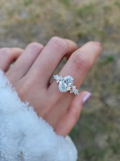 a woman's hand with a diamond ring on it