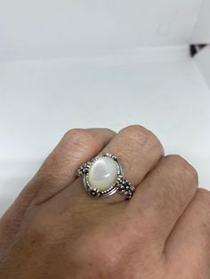 Lovely polished 925 sterling silver with a huge white Mother Of Pearl set in very detailed vintage filigree Size 7 or 9 We can size these with an additional $10- $20 fee for the jeweler All rings are shipped in a nice gift box. Check out our over a THOUSAND great reviews Engraving is $4 per letter and is not always perfect depending on the piece. It can take a few days if the jeweler is busy. This is payable to Paypal Judithsltd@gmail.com Elegant White Oval Cabochon Moonstone Ring, Elegant White Moonstone Ring With Oval Cabochon, Elegant White Moonstone Ring, Oval Cabochon, Classic White Filigree Ring With Intricate Design, White Sterling Silver Pearl Ring Gift, White Oval Cabochon Ring As Gift, White Oval Cabochon Ring For Gift, Classic White Oval Moonstone Ring, White Oval Cabochon Moonstone Ring For Anniversary