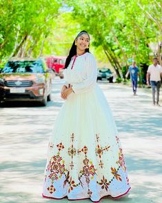 This Habesha Kemis is a true masterpiece of traditional Ethiopian fashion, with its exquisite Menen fabric and intricate Tilf design. The Menen fabric is renowned for its softness and durability, making this Kemis not only beautiful but also comfortable to wear. The Tilf design is intricate and delicate, with a pattern that is both modern and traditional, with clean lines and bold shapes that create a unique and eye-catching look. The Tilf design extends down the front of the Kemis, creating a v Ethiopian Fashion, Eritrean Dress, Habesha Dress, Habesha Kemis, Traditional Jewelry, A Pattern, Clean Lines, Formal Event, Timeless Fashion