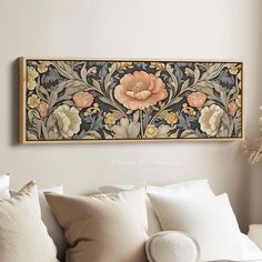 an ornately decorated wall hanging above a couch with pillows and throw pillows on it