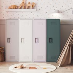 three lockers in a child's room with toys on the floor next to them