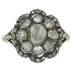 Here we have a wonderful example of Georgian craftsmanship. This multi-layered cluster ring features an oval shaped rose cut diamond at the centre which is circulated by a slightly smaller array of matching rose cut diamonds. Multiple convex motifs make up the frame to the outer exterior; each of which is set with a trio of tiny rose cut diamonds. All stones here are set in silver on a closed gold backing; a feature typical of the period, however, the neatly engraved patterned band has been crafted entirely from 15ct yellow gold. Condition: Used (Very Good) Weight: 3.8 grams Size: K (50) Face Dimensions: 16mm x 15mm Band Width: 1mm Centre Diamond Weight: Approx. 0.30ct (spreads 0.50ct) Remaining Diamond Weight: Approx. 0.42ct Tested As: 15ct Gold & Silver Period: Georgian Box: The Vintage Exquisite Rose Cut Diamond Cluster Ring, Antique Rose Cut Diamond Cluster Ring For Anniversary, Luxury Antique Cluster Ring, Georgian Cluster Ring, Luxury Antique Hallmarked Cluster Ring, La Face, Diamond Cluster Ring, Diamond Cluster, Rose Cut Diamond