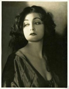 an old black and white photo of a woman with her eyes closed, looking to the side