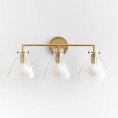 three light brass bathroom fixture with clear glass shades