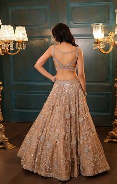 This gold lehenga features hand embroidered 3D flowers throughout along with sequin,crystal, pearl and cutdana embroidery. It is paired with a matching embroidered V neck blouse detailing,and an embroidered dupatta.From Isa by Dolly Wahal's Fiori collection.DELIVERY TIMEPlease allow 8-12 weeks for your outfit to arrive.FABRIC DETAILSNetProfessional cleaning only. Luxury Gold Embroidered Lehenga For Festive Occasions, Gold Embroidered Lehenga For Diwali, Gold Embroidered Lehenga For Party, Semi-stitched Gold Embroidered Lehenga For Parties, Gold Embroidered Lehenga, Indian Lengha, Cutdana Embroidery, Gold Lehenga, Embroidered Dupatta