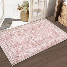 a pink area rug in front of an open door