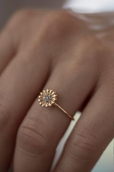 Feeling bohemian?Take this ultra feminine  minimalistic boho daisy ring and declare yourself a champion of laid back cool.Handmade to order in 14K solid Rose Gold with a delicate band, this is not your ordinary daisy motif.Flower power is here to stay and has never looked so good!This is a modern way to wear floral jewelry as imagined by Atelier Petites Pierres, proprietors of beautiful jewelry fashioned from high quality materials and craftsmanship.A fourteen petal design sculpted in light reli Rose Gold Flower Ring For Promise, Rose Gold Flower Promise Ring, Delicate Flower Ring With Rose Cut Diamonds For Wedding, Delicate Birth Flower Promise Ring, Bohemian Rose Gold Jewelry For Wedding, Rose Gold Flower Proposal Ring, Delicate Flower Ring For Promise, Dainty Flower Ring With Flower Charm, Delicate Promise Rings With Birth Flower