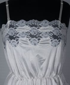 Here's a sweet and lovely vintage camisole you'll adore. This late 70s / 80s crossover brand cami has an original Ashley Taylor label and great boho style. You'll love feeling groovy in this hourglass top and you'll love wearing it with your other period collectibles. This figure-flattering ivory colored, lace trimmed camisole top is in excellent condition with signs of wear/use and portion of stretched waistband that still works and stretches in and out just fine - see last close up picture. Th Vintage Sleeveless Top With Built-in Bra, Fitted Vintage Camisole, Vintage Lace Trim Camisole Tank Top, Vintage Lace Trim Tank Top, Vintage Sleeveless Camisole With Built-in Bra, Vintage Camisole Top For Daywear, Summer Vintage Top With Built-in Bra, Vintage Cami Top For Daywear, Vintage Cami Tank Top With Lace Trim