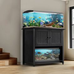 a fish tank sitting on top of a cabinet in a room with stairs and windows