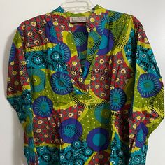 100 % Cotton Tunic Blouse,Never Worn But Tags Gone. Washable. Colorful Tunic Style. Casual Multicolor V-neck Tunic, Green V-neck Top With Vibrant Print, Multicolor Long Sleeve Relaxed Fit Blouse, Summer Multicolor Split Neck Tops, Multicolor Split Neck Top For Summer, Multicolor Split Neck Summer Top, Multicolor Print Long Sleeve Tops For Vacation, Casual Multicolor Split Neck Top, Multicolor V-neck Shirt For Beach