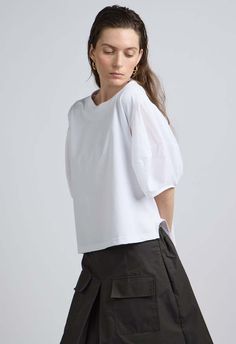 One size. fits xs-xl  color: white  puff sleeve  regular fit  split waist detail  designed for casual fit  lightweight fabric  80% cotton 20% nylon  dry clean only  by the nkc store    product measurements:  bust: 118.87cm / 46.8in  length: 53.97cm / 21.25in Relaxed Fit Tops With Blouson Balloon Sleeves, White Cotton Puff Sleeve Shirt, Casual Tops With Blouson Sleeves Relaxed Fit, Cotton Balloon Sleeve Blouse With Cuffed Sleeves, Cotton Blouse With Balloon Cuffed Sleeves, Cotton Puff Sleeve Shirt In Relaxed Fit, Cotton Relaxed Fit Shirt With Puff Sleeves, Long Sleeve Poplin Tops For Summer, Relaxed Fit Cotton Shirt With Puff Sleeves