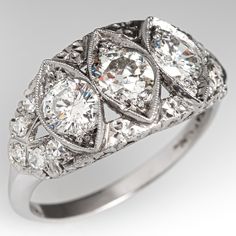 This elegant circa 1930s ring is centered with one (1) old European cut diamond and flanked to each side by one (1) round brilliant cut diamond that are bead set into navette shaped setting. The shoulders of the ring are each accented with five (5), bead set, round single cut diamonds. The ring measures 10.6mm at the top, rises 4.5mm above the finger, tapering to 2.0mm wide and 1.2mm thick at the base of the shank. This ring is currently a size 7.5. One of the accent diamonds is chipped but noth Antique Three Stone Round Diamond Ring, Antique Platinum Three Stone Diamond Ring, Antique Oval Three Stone Diamond Ring, Antique Three Stone Diamond Ring In Diamond White, Art Deco Three Stone Platinum Jewelry, Art Deco Marquise Diamond Ring With Center Stone, Art Deco Diamond Three Stone Ring, Art Deco Three Stone Diamond Ring, Antique Platinum Three Stone Rings