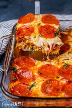 a slice of pepperoni pizza being lifted from a casserole dish