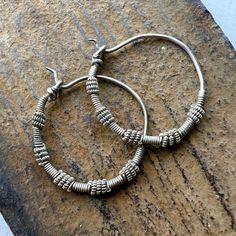 A pair of old silver Hoop earring from Afghanistan - Kuchi people. 28mm  wide - 1 1/8" inches  2mm wire through hole - thicker than Western earwires. 5.8 grams Traditional Adjustable Hoop Jewelry, Traditional Adjustable Small Hoop Jewelry, Artisan Silver Round Hoop Earrings, Everyday Silver Oxidized Hoop Earrings, Handmade Silver Metal Hoop Earrings, Bohemian Hand Forged Hoop Earrings For Everyday, Handmade Spiral Silver Hoop Earrings, Artisan Oxidized Hoop Earrings, Artisan Handmade Silver Hoop Earrings