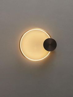 a light that is on the side of a wall with a circular light in it