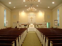 an empty church with pews and chandelier