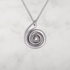 Smooth spiral pendant suspended from an 18" chain Pendant measures 3/4" x 1" Sterling silver or 14k gold fill chain Spiral Wire Wrapped Sterling Silver Necklace, Spiral Hand Forged Sterling Silver Jewelry, Unique Spiral Sterling Silver Necklace, Nickel-free Sterling Silver Swirl Necklace, Unique Silver Spiral Necklace, Minimalist Spiral Silver Jewelry, Silver Spiral Metal Necklaces, Silver Spiral Metal Necklace, Hand Forged Silver Spiral Necklace