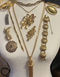 Beautiful estate collection of 12 signed Monet vintage goldtone jewelry pieces. 1950s-1980s. Includes: 3 Necklaces (1950s adjustable choker; Short length chain necklace with rhinestone chevron; 1960s long double chain necklace with chain tassel.) 4 Bracelets (1950s circle link wrap bracelet with guard chain, 1 hinged bangle, 1 bangle, 1 charm link bracelet with panel for engraving.) 5 brooches including an exclusive Monet insignia brooch (MONET New York London Paris) that was a company gift for attendees at a New York fashion show event. Very good vintage condition. Light surface wear typical of age and/or use.  You will receive the exact pieces shown in the photos. View the photos for dimensions and condition and please feel free to contact me with any questions or concerns before placing Luxury Vintage Hinged Jewelry, Monet Costume Jewelry, Victorian Gold Brooch Jewelry, Antique Gold Brooches With Jewels, Victorian Gold Brooches With Jewels, Mid-century Yellow Gold Brooch Jewelry, Gold Jeweled Brooch For Formal Occasions, Mid-century Gold Necklace Gift, Mid-century Yellow Gold Brooch