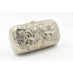 Elegant Judith Leiber silver metal and crystal oblong evening bag clutch featuring a scrolling foliage flower design on a silver - toned metal bag.  The hardware is silver.  It has a silver leather interior with a silver shoulder strap that can be folded inside when you want to wear it as a clutch.  There is a circle that folds out to hold a tassel, but it is no longer there.  Labeled ‘Judith Leiber/New York’ in the interior. 5.5” W x 3” H x 1.5” D  A similar one sold at Chrisities from Joan Riv Luxury Silver Clutch, Luxury Formal Clutch With Silver-tone Hardware, Luxury Metallic Silver Bag For Formal Occasions, Luxury Silver Clutch For Evening, Luxury Silver Rectangular Evening Bag, Elegant Silver Bag With Silver-tone Hardware, Elegant Rectangular Metallic Silver Bag, Silver Clutch For Formal Occasions, Silver Evening Clutch With Silver-tone Hardware