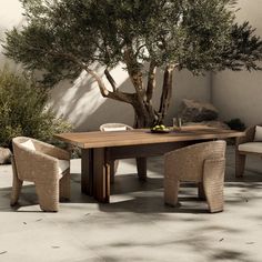 an outdoor dining table with chairs and a tree in the background on a tile floor