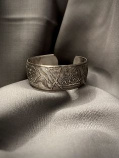 A vintage sterling silver bangle with hand engraved detailing  - Total weight: 21.8 grams - Total inside diameter: 2" inches, can be adjusted to be wider *Item worn, sold as is* Ornate Stamped Bracelets For Formal Occasions, Adjustable Engraved Antique Silver Ring, Silver Etched Cuff Bracelet For Wedding, Formal Engraved Bangle Cuff Bracelet, Heirloom Etched Bangle For Ceremonial Occasion, Ceremonial Heirloom Etched Bangle, Antique Silver Engraved Cuff Bracelet, Silver Etched Cuff Bracelet, Ornate Engraved Sterling Silver Bracelet For Anniversary