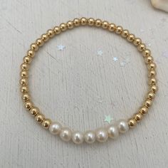 For the girls who love pearls, seven freshwater pearls on a golden strand are the epitome of a classic piece and any jewelry lovers must have! Sure to become your new favorite everyday staple. 4mm quality gold fill beads strung on super strong stretch cord accented 6mm pearls. A classic piece that you'll love and want to wear time and again. How to figure out your wrist size: use a soft measuring tap to measure your wrist. make sure to wrap the measuring tape around your wrist so that it makes c Classic Gold Pearl Beaded Bracelets, Classic Gold Bracelet With Pearl Drop, Classic Gold Pearl Bracelet With Gold Beads, Gold Pearl Jewelry With 8mm Beads, Classic Gold Pearl Drop Bracelet, Classic Gold Bracelets With Pearl Charm, Gold Pearl Bracelet With 8mm Beads, Classic Gold Pearl Bracelet Hypoallergenic, Classic Gold Pearl Bracelet With Round Beads