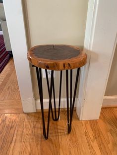 a small wooden table with metal hairpin legs