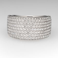 This sparkling wide band diamond ring is accented along the top half with two-hundred twenty-one (221), bead set, round brilliant cut diamonds. The ring measures 11.7mm at the top, rises 3.8mm above the finger, tapering to 5.7mm wide and 1.2mm thick at the base of the shank. The ring currently fits like a size 8. We are able to offer limited sizing on this one, please call with sizing questions. Modern Wide Band Diamond Ring With Vvs Clarity, Luxury Wide Band Diamond Ring With Diamond Cut, Luxury Wide Band Ring With Diamond Accents For Wedding, Dazzling Wide Band Diamond Ring For Wedding, Luxury Wide Band Wedding Ring With Diamond Accents, Wide Band Wedding Ring With Single Cut Diamonds, Modern Diamond Ring With Brilliant Cut And Wide Band, Vvs Clarity Diamond Wide Band Ring For Wedding, Wide Band Diamond Ring Vvs Clarity For Wedding