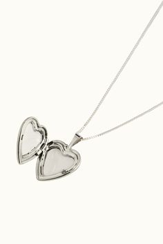 Lisbeth Heart Locke Necklace. A timeless heart locket that feels both nostalgic yet modern. A true classic that signifies the most special of things are held close to the heart. Featuring a smooth finish on both sides and hanging from a traditional box chain, our Classic Heart Locket is a modern heirloom. Locket measures 16mm 20" Length Sterling Silver Handmade in Toronto, Canada Parc Shop Sterling Silver Locket Necklace, Silver Locket, Heart Locket Necklace, Silver Lockets, Silver Heart Necklace, Heart Locket, 50th Gifts, Toronto Canada, Locket Necklace