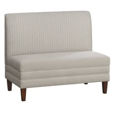 a white couch with wooden legs and a striped upholstered back rest on an isolated white background