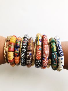 Beautiful, stylish African bracelets handmade from glass by artisans in Ghana. They come in a variety of unique color combinations and patterns, the more you wear, the better. Sizes:Wide-1/2”W Each bracelet is one of a kind and fits wrist size 6-7. Available as a single bracelet or set of 3. Each bracelet is one-of-a-kind and may vary slightly but will be similar to the bracelets pictured. Multiple bracelets are pictured to show variation, however each bracelet is sold individually. Earthy Jewelry Beth Millner Jewelry, American Indian Jewelry 1stdibs, Affordable Traditional Beads For Gifts, Bead Shopping, Afro Jewelry, Ancient Beads, Dope Jewelry Accessories, African Bracelets, Single Bracelet