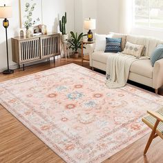 a living room filled with furniture and a large rug